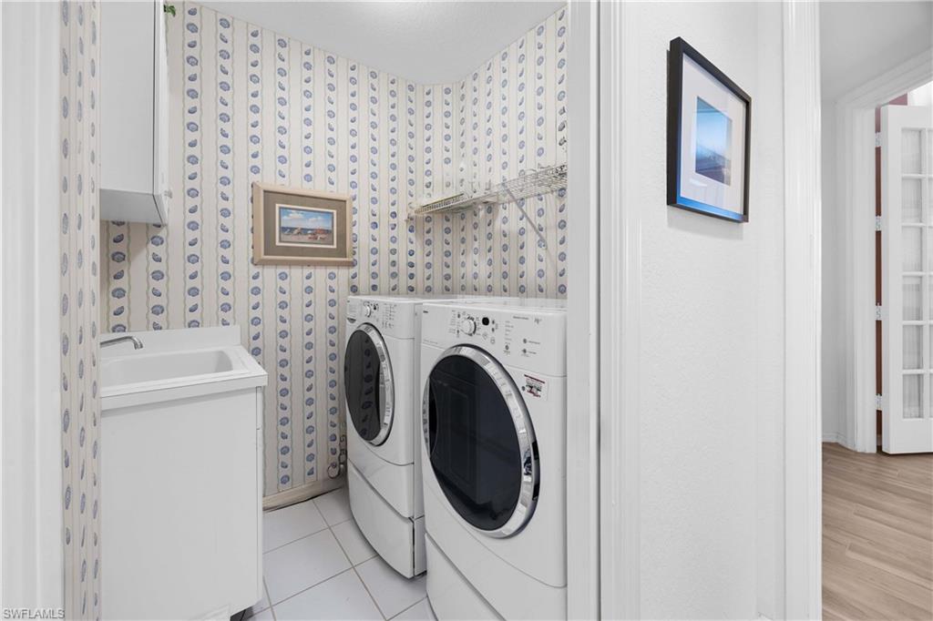 1826 Seville Boulevard, Unit 1012 Naples, FL 34109 - Photo 22 of 50 a utility room with dryer and washer