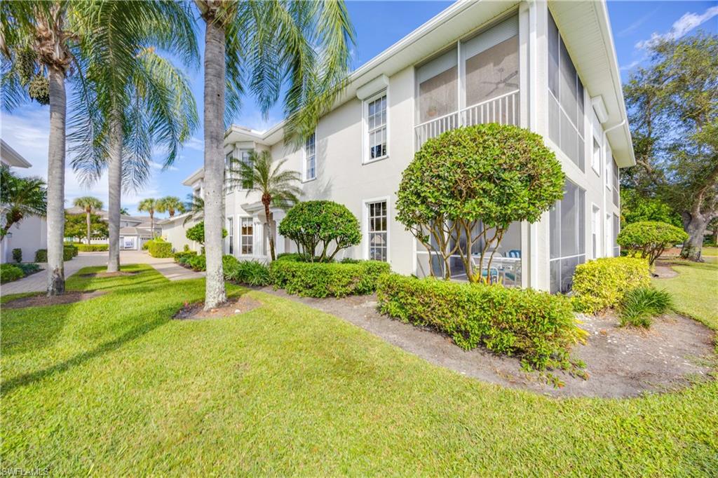 1826 Seville Boulevard, Unit 1012 Naples, FL 34109 - Photo 24 of 50 a view of a garden with a building