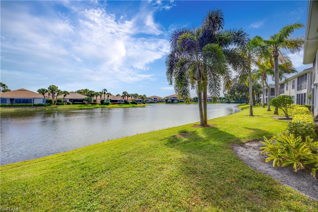 1826 Seville Boulevard, Unit 1012 Naples, FL 34109 - Photo 26 of 50 a view of a lake with houses in the back