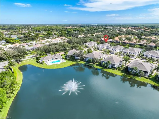 an aerial view of a houses with a lake view