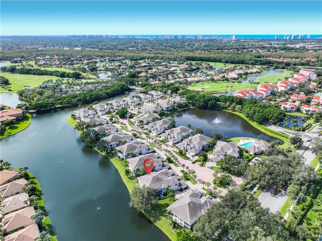 1826 Seville Boulevard, Unit 1012 Naples, FL 34109 - Photo 29 of 50 an aerial view of a houses with a lake view