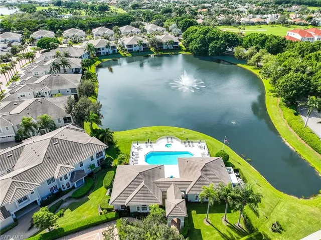 an aerial view of a house with swimming pool and garden