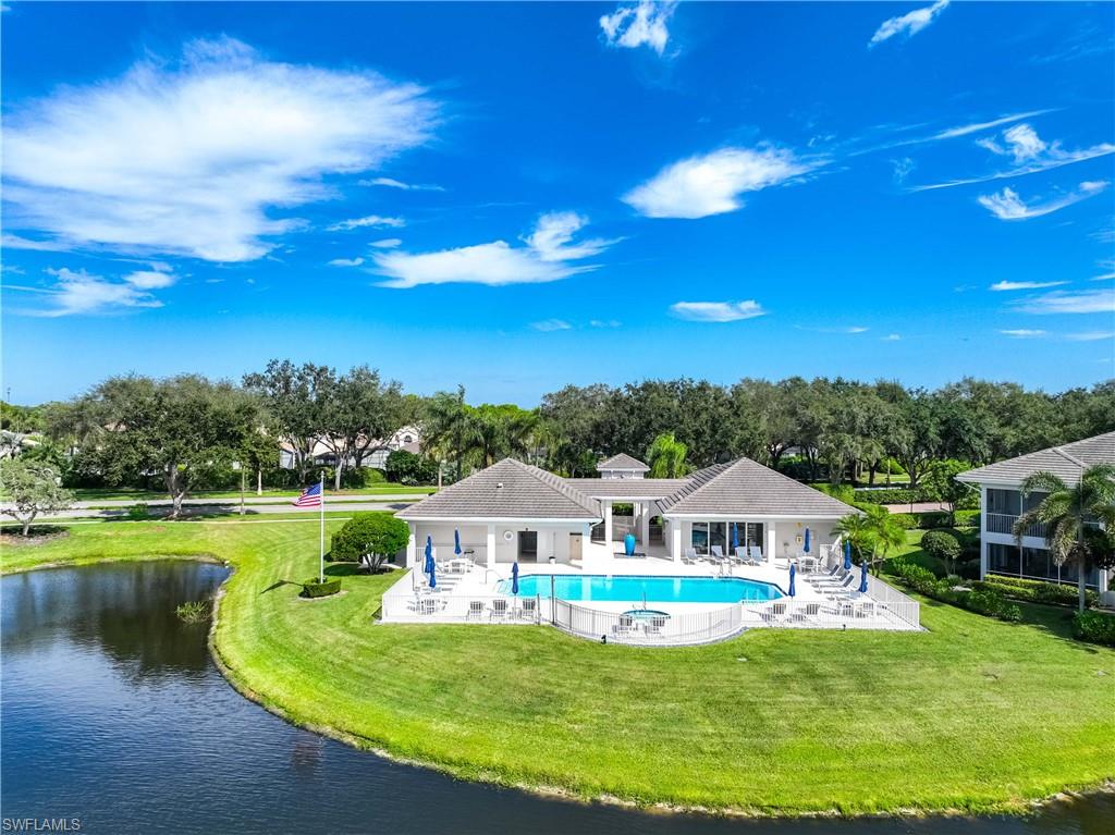 1826 Seville Boulevard, Unit 1012 Naples, FL 34109 - Photo 32 of 50 a view of a house with swimming pool yard and lake view