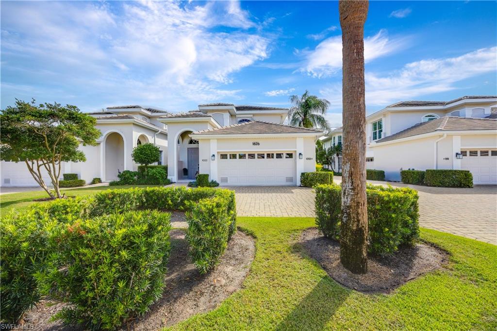 1826 Seville Boulevard, Unit 1012 Naples, FL 34109 - Photo 5 of 50 a front view of a house with garden