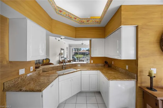 a kitchen with a sink a stove and cabinets