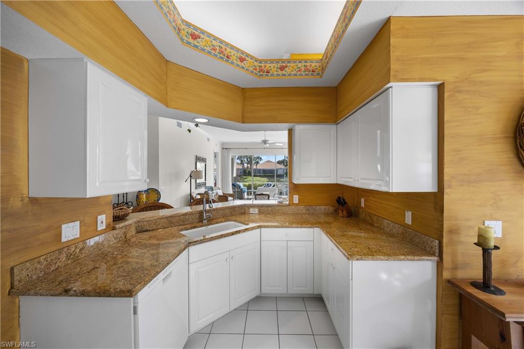 1826 Seville Boulevard, Unit 1012 Naples, FL 34109 - Photo 10 of 50 a kitchen with a sink a stove and cabinets