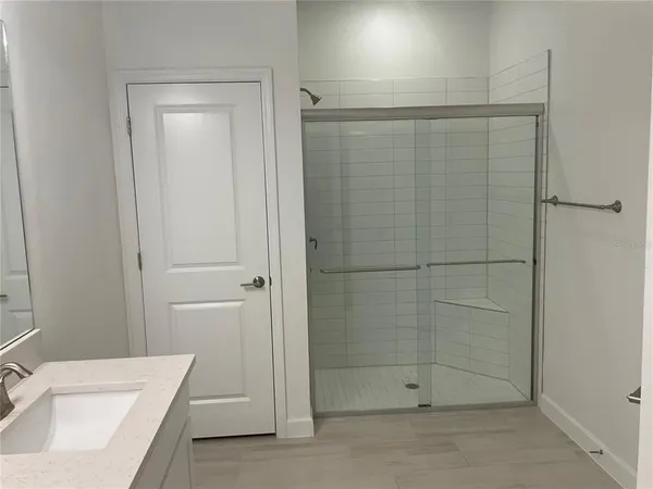 a bathroom with a shower and a sink