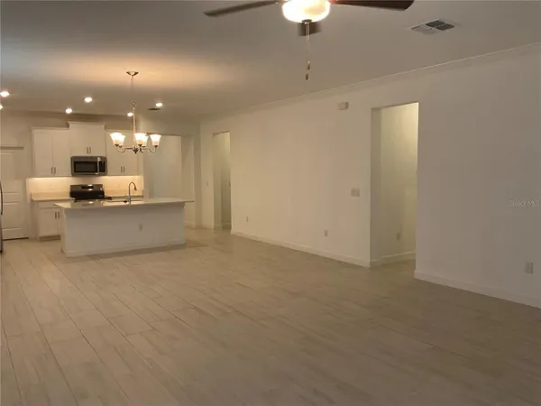 a view of kitchen and a refrigerator chandelier