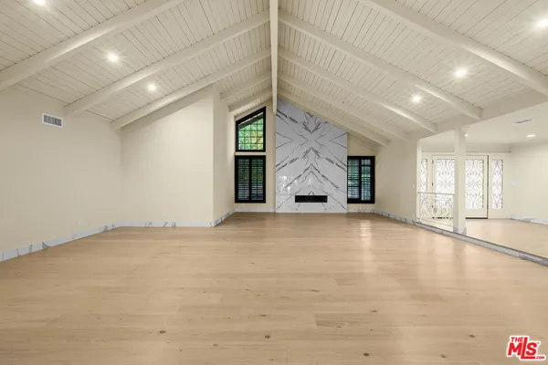 a large white kitchen with a large window