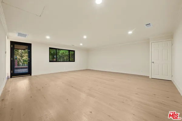 a spacious bedroom with a large bed and a large window