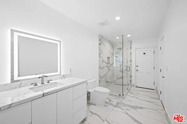 a white bath tub sitting next to a shower