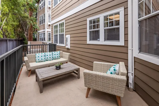 a view of a bench in back side of building