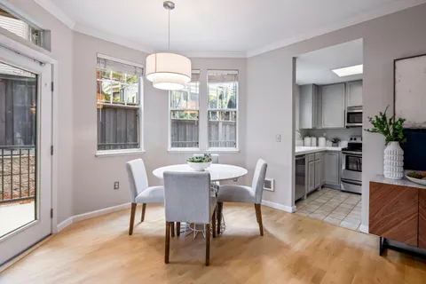 a dining room with furniture a chandelier and wooden floor