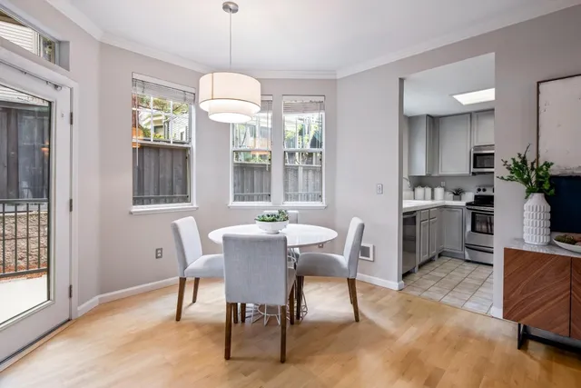 a dining room with furniture a chandelier and wooden floor