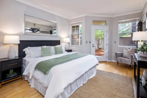 a bedroom with bed and a night stand