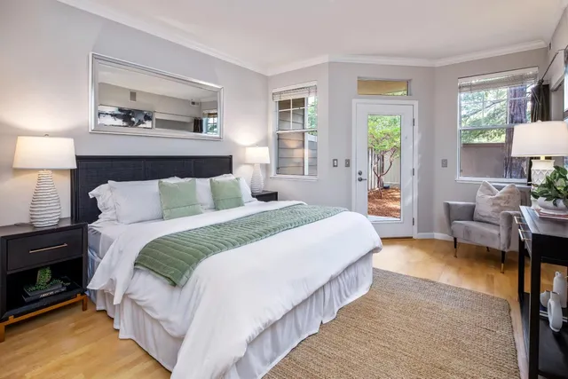 a bedroom with bed and a night stand