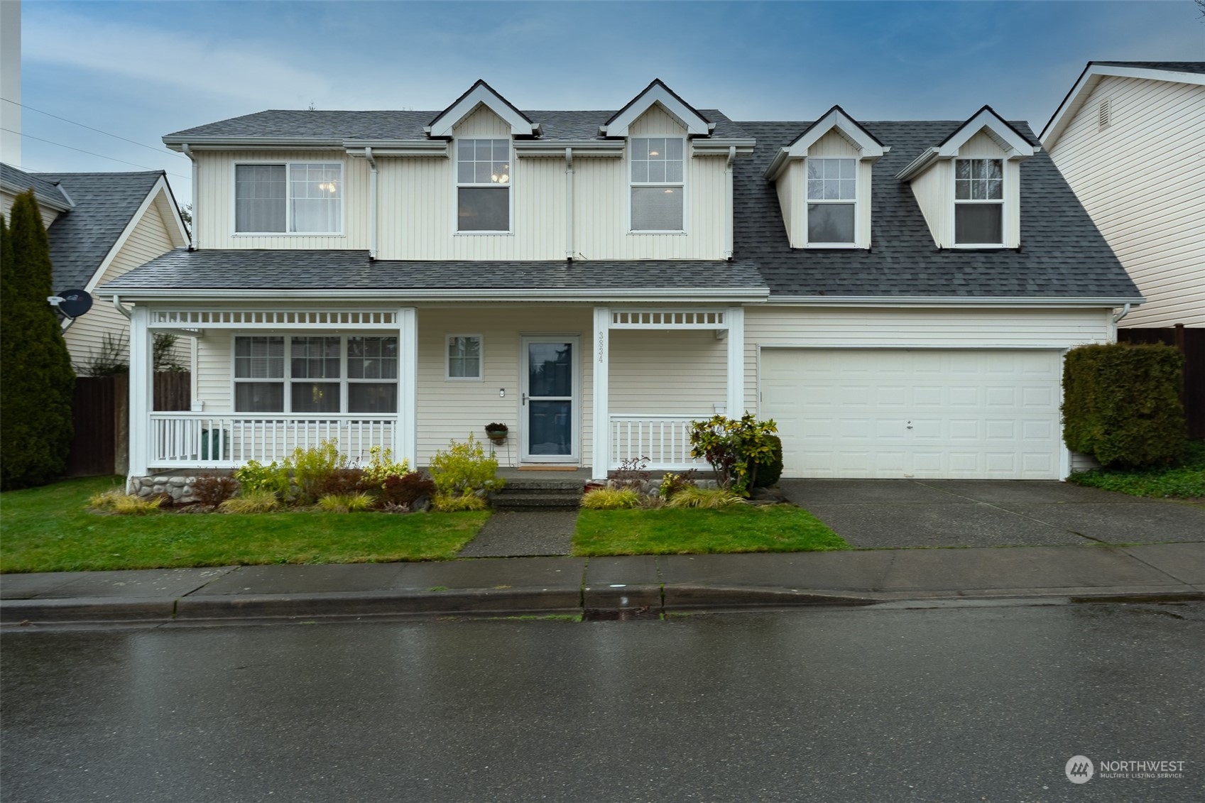 3834 Northeast 5th Place Renton, WA 98056 - Photo 9 of 39 a front view of a house with a yard and garage