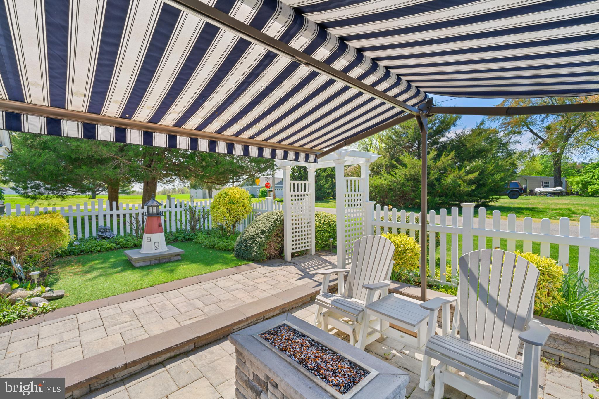 14100 Turners Point Road Kennedyville, MD 21645 - Photo 22 of 45 Stone patio with waterfall, fire pit and awning
