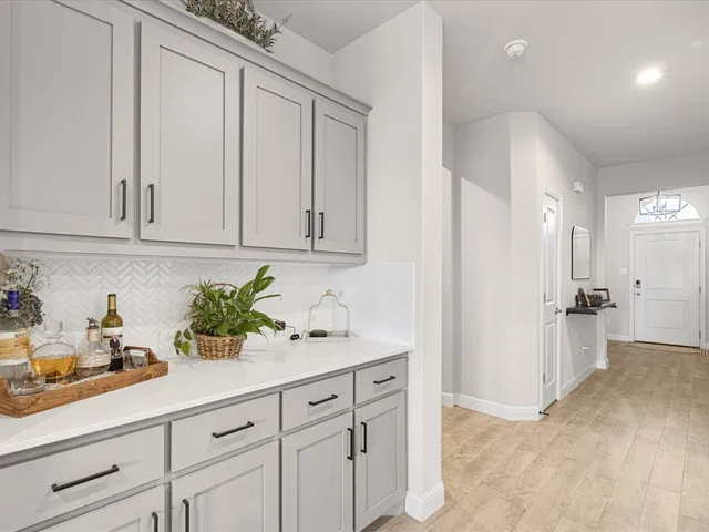 a kitchen with white cabinets and a sink