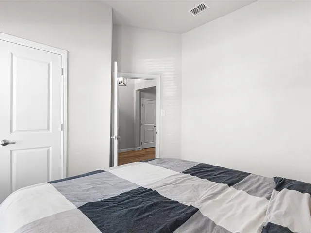 a bedroom with a bed and a mirror