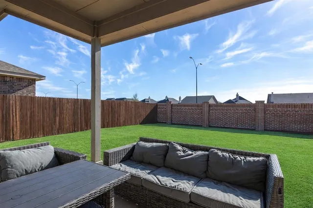 a view of yard with patio