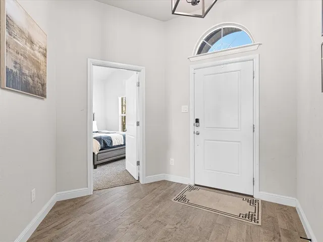 an entryway view with a wooden floor and a sink