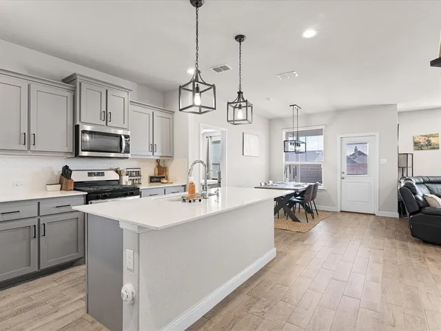 a kitchen with a sink a stove and microwave