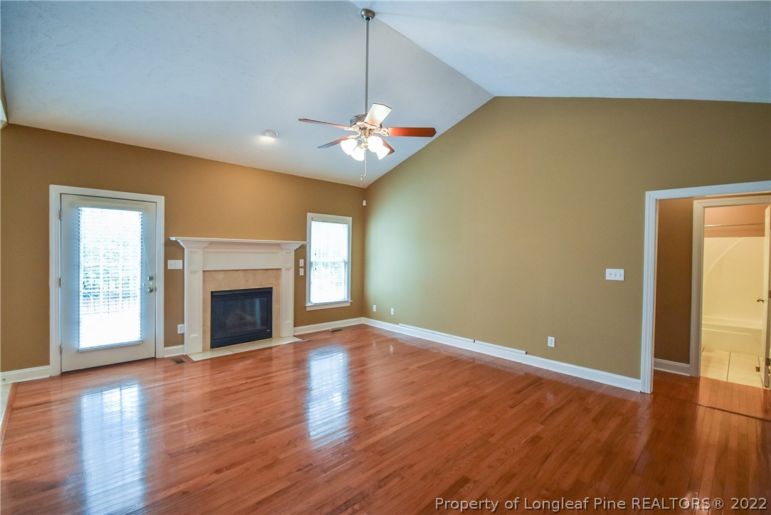 36 Falling Water Road Spring Lake, NC 28390 - Photo 11 of 50 a view of an empty room with wooden floor and a fireplace