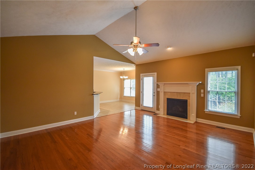 36 Falling Water Road Spring Lake, NC 28390 - Photo 14 of 50 a view of an empty room with a fireplace and wooden floor