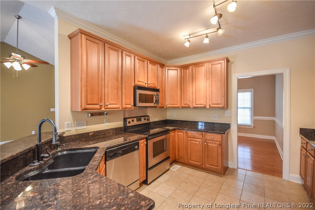 36 Falling Water Road Spring Lake, NC 28390 - Photo 16 of 50 a kitchen with stainless steel appliances granite countertop a sink and cabinets