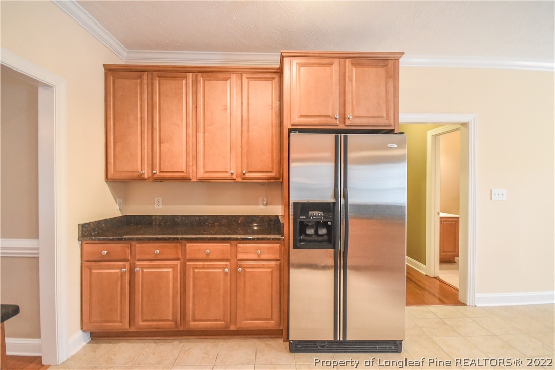 36 Falling Water Road Spring Lake, NC 28390 - Photo 19 of 50 a kitchen with a window a refrigerator and wooden cabinets