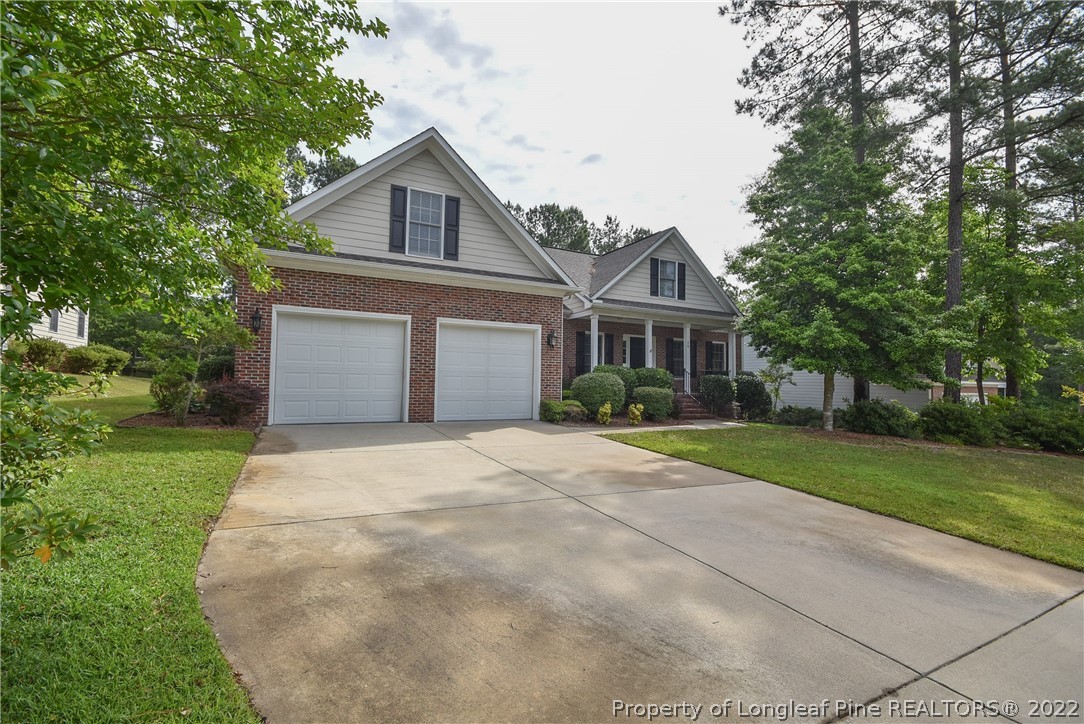 36 Falling Water Road Spring Lake, NC 28390 - Photo 2 of 50 a front view of a house with a yard and garage