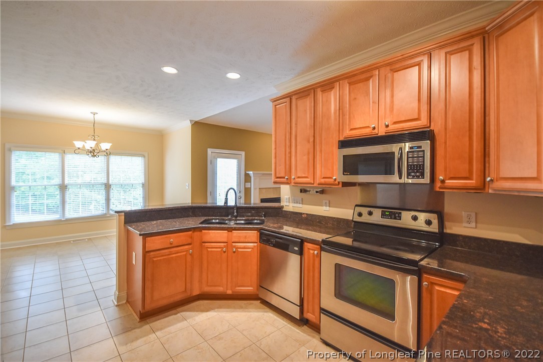 36 Falling Water Road Spring Lake, NC 28390 - Photo 21 of 50 a kitchen with stainless steel appliances granite countertop a stove sink and cabinets