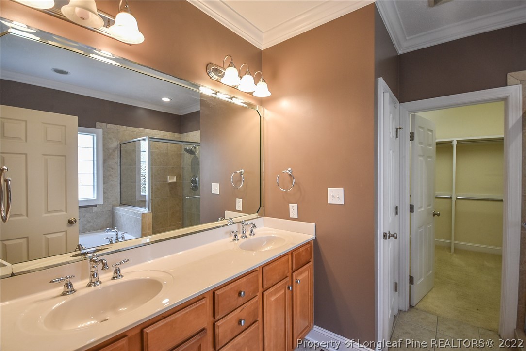 36 Falling Water Road Spring Lake, NC 28390 - Photo 31 of 50 a bathroom with a double vanity sink and a mirror