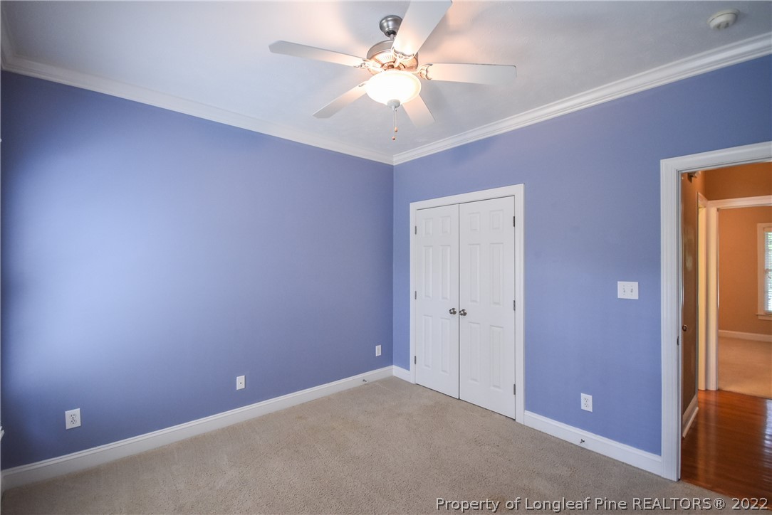 36 Falling Water Road Spring Lake, NC 28390 - Photo 42 of 50 an empty room with a chandelier fan and windows