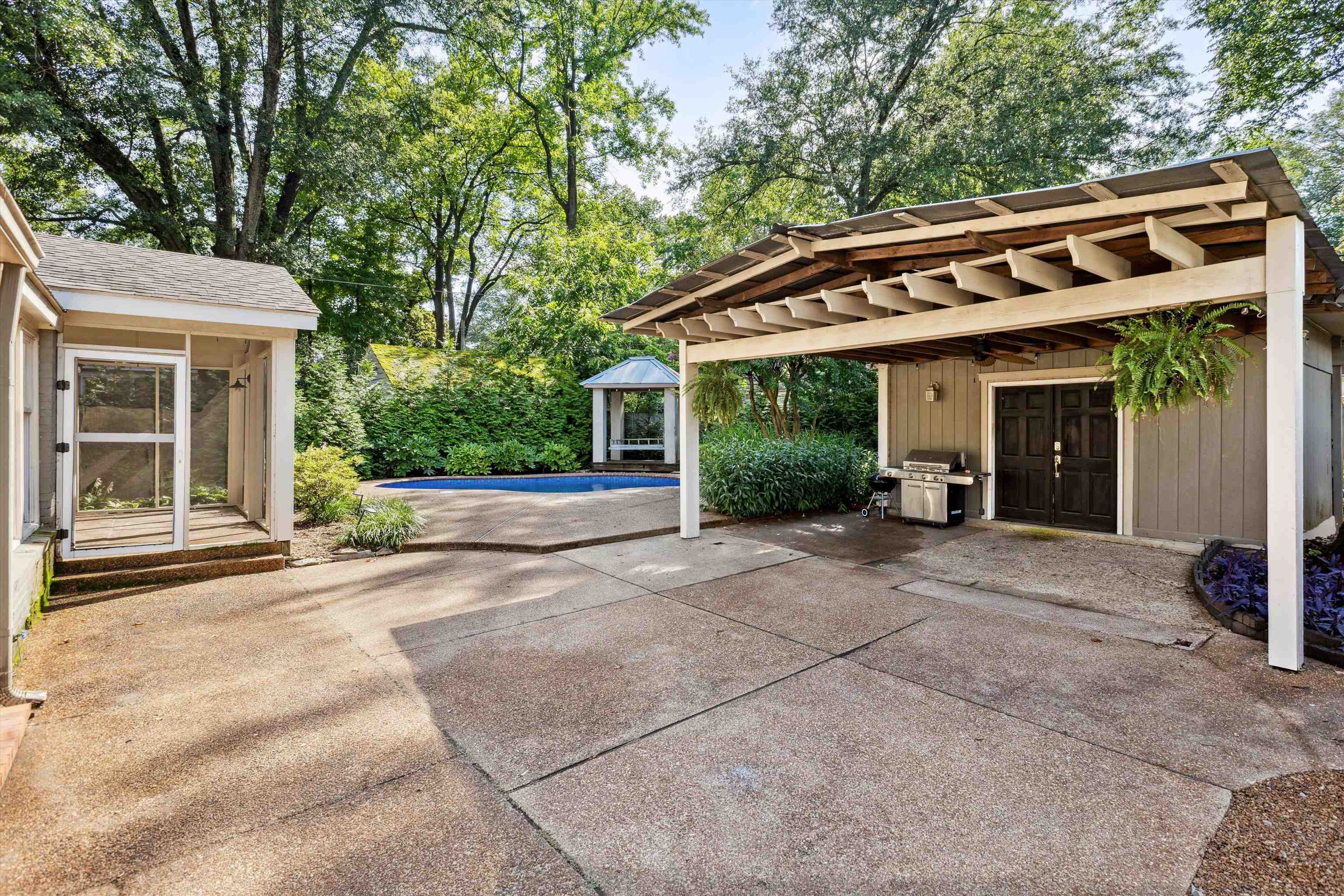 175 Dille Place Memphis, TN 38111 - Photo 23 of 25 View of patio / terrace featuring grilling area, an outdoor pool, and a detached garage