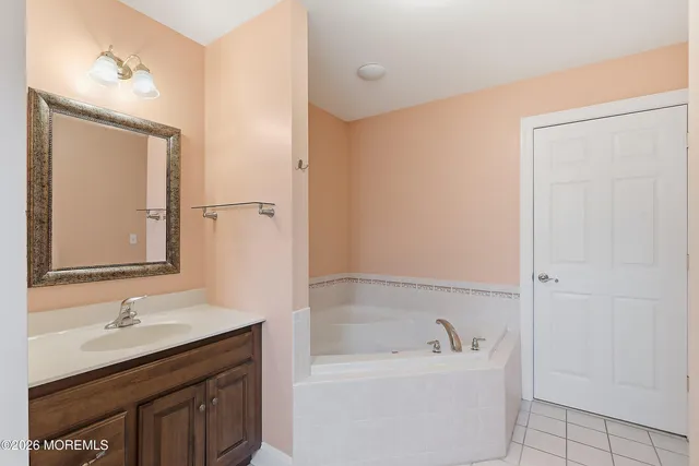 a bathroom with a bathtub sink double and mirror