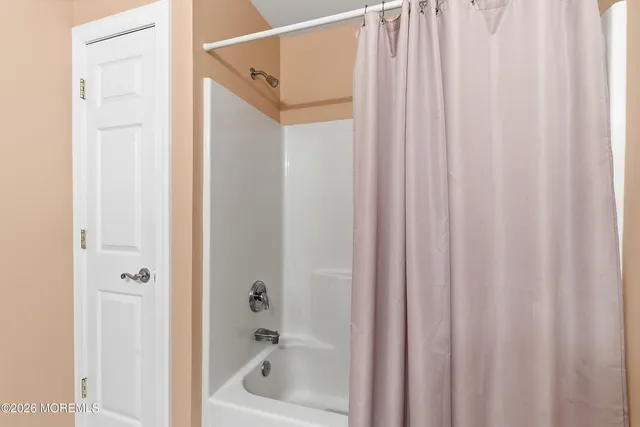 a bathroom with a shower and a tub