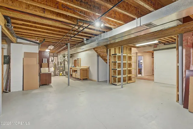 a view of an empty room with wooden ceiling