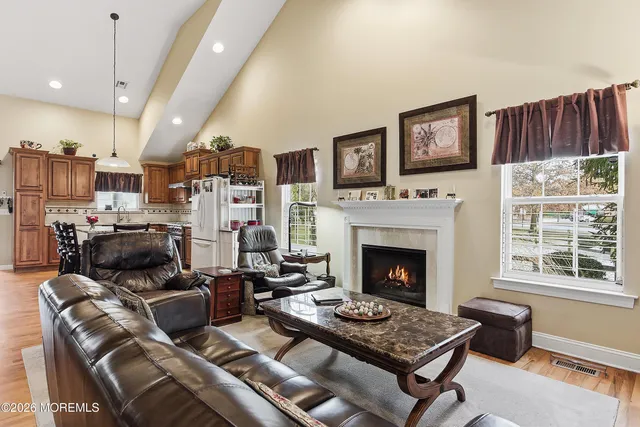 a living room with furniture fireplace and flat screen tv