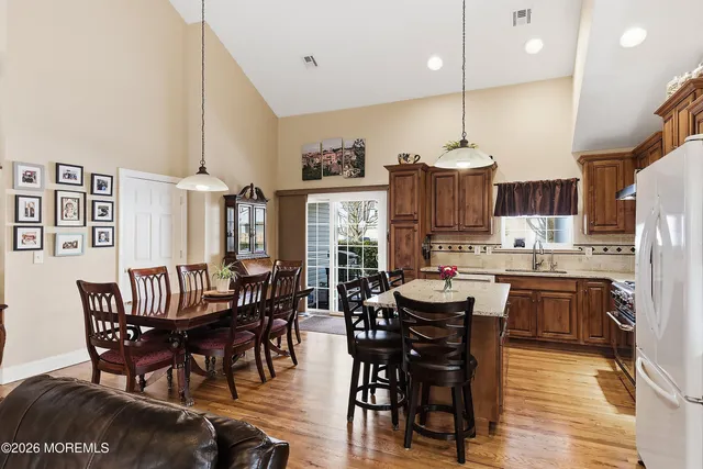 a view of a dining room with furniture kitchen and chandelier