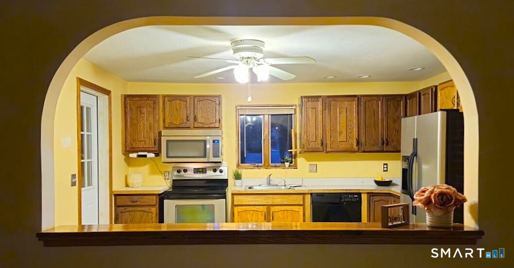 35 Lardner Road Bristol, CT 06010 - Photo 12 of 40 a kitchen with stainless steel appliances granite countertop a stove and a refrigerator