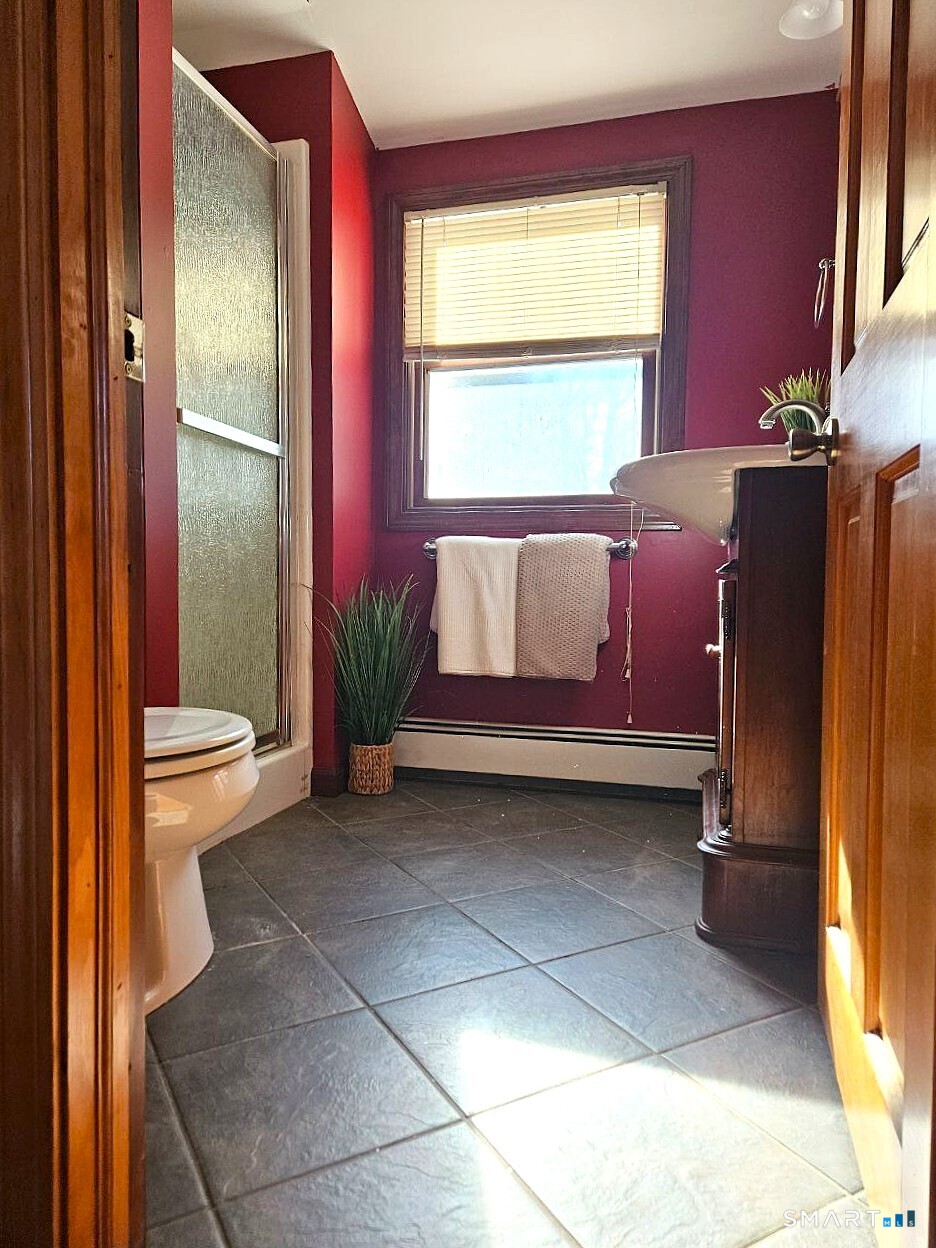 35 Lardner Road Bristol, CT 06010 - Photo 19 of 40 a living room with a couch and a potted plant