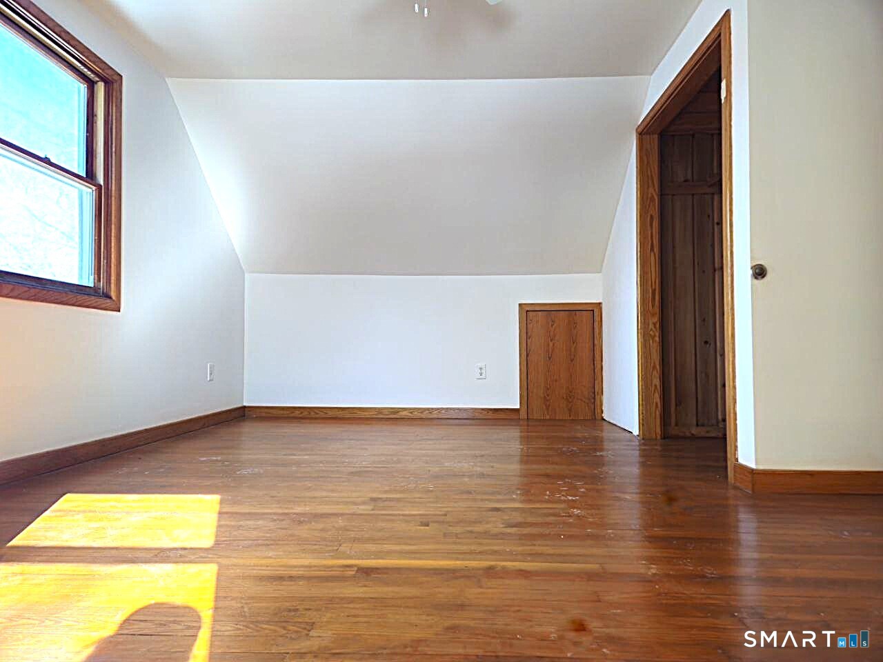 35 Lardner Road Bristol, CT 06010 - Photo 21 of 40 a view of an empty room with wooden floor and a window