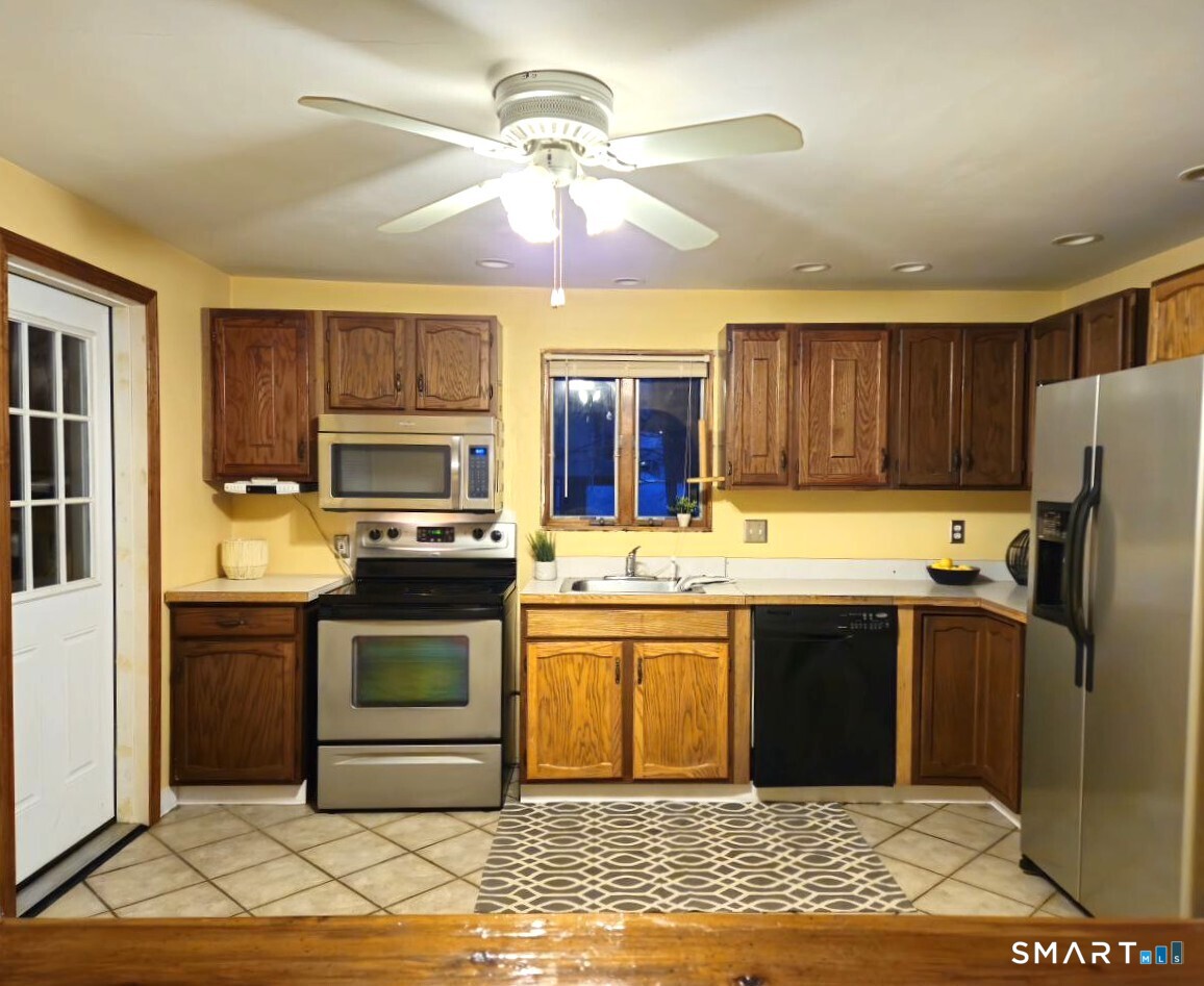 35 Lardner Road Bristol, CT 06010 - Photo 34 of 40 a kitchen with stainless steel appliances granite countertop a sink stove and refrigerator