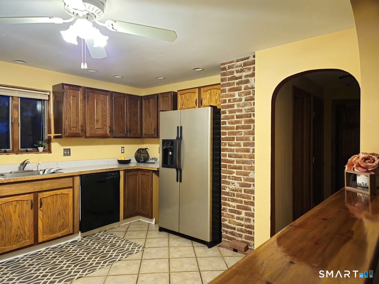 35 Lardner Road Bristol, CT 06010 - Photo 36 of 40 a kitchen with a sink a refrigerator and cabinets