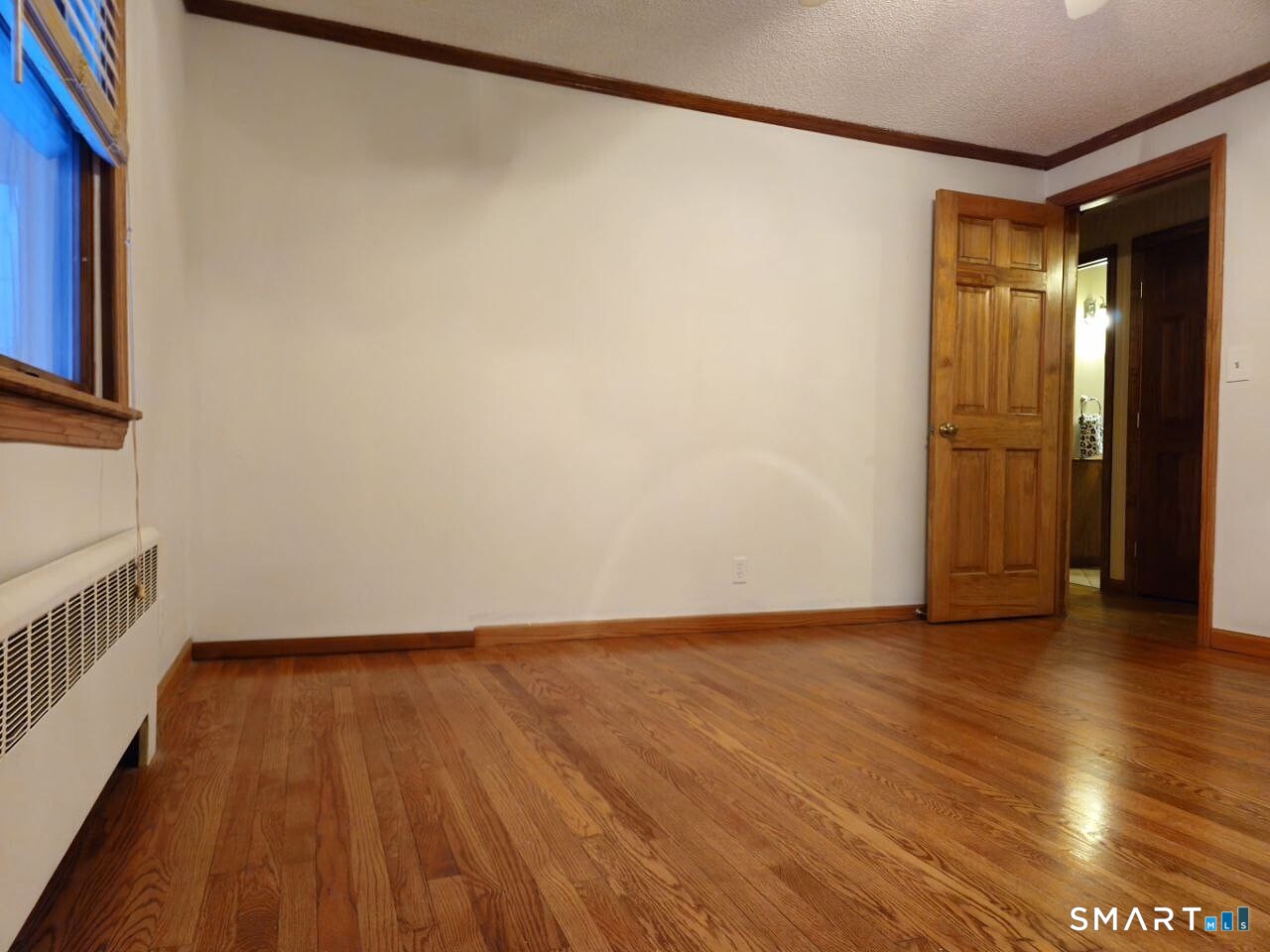35 Lardner Road Bristol, CT 06010 - Photo 37 of 40 a view of an empty room with wooden floor and a window