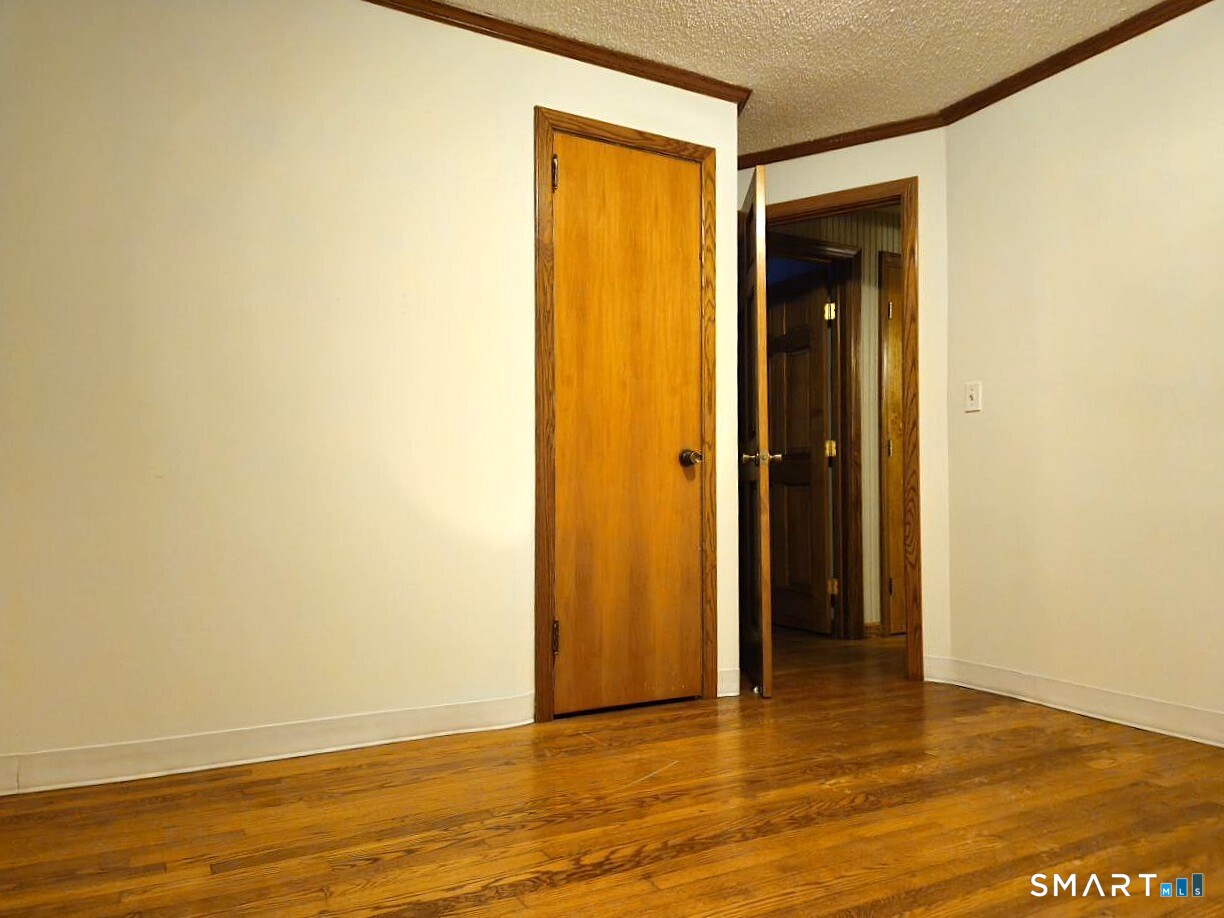35 Lardner Road Bristol, CT 06010 - Photo 39 of 40 a view of an empty room with wooden floor and closet