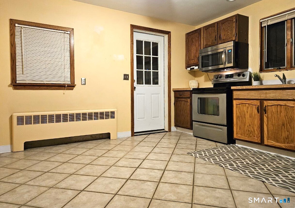 35 Lardner Road Bristol, CT 06010 - Photo 4 of 40 a kitchen with stainless steel appliances a stove a sink and a microwave