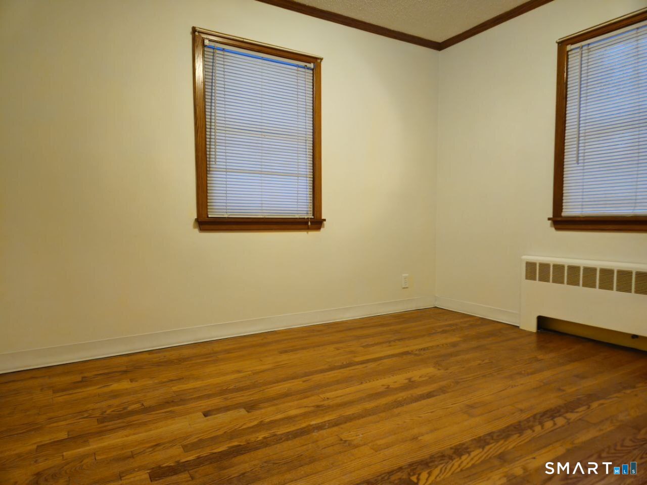 35 Lardner Road Bristol, CT 06010 - Photo 9 of 40 a view of an empty room with wooden floor and a window